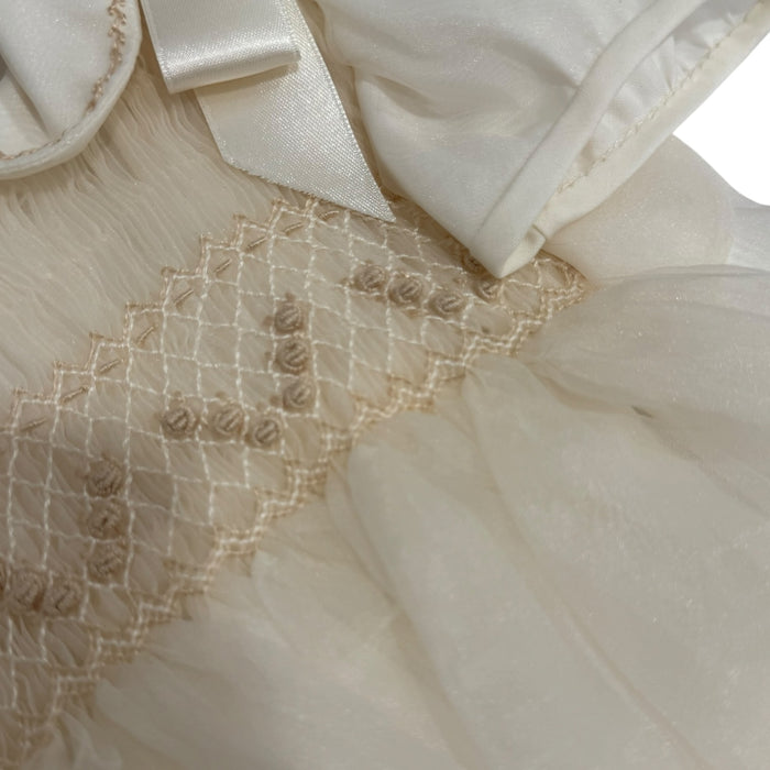 Close-up of ruffled collar and tonal detailing on Adrian Ivory Romper