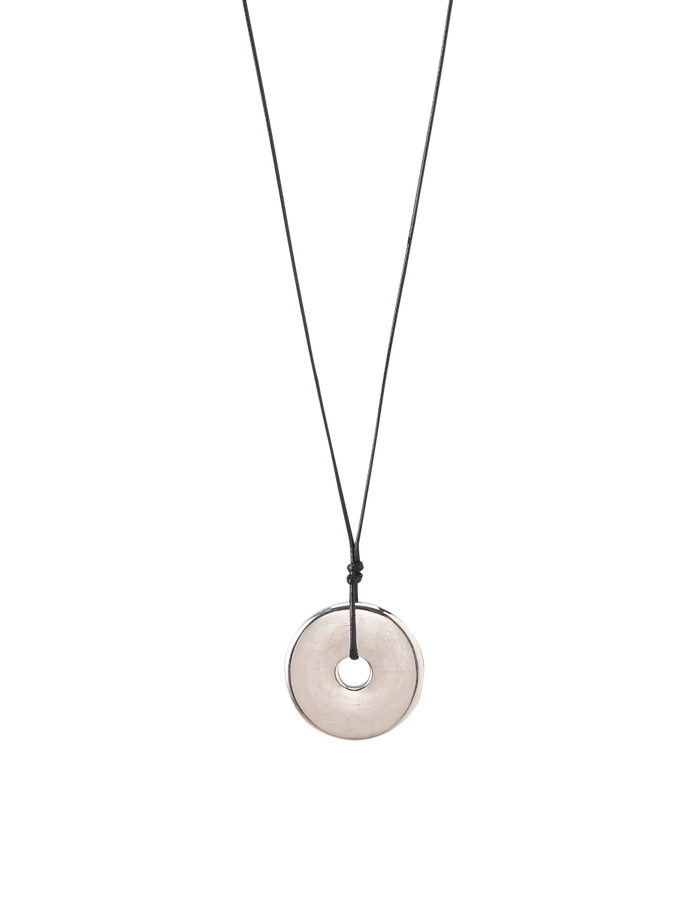 The TIGERMIST AIFE PENDANT NECKLACE - SILVER features a minimalist black adjustable cord and a translucent circular pendant with a central hole, displayed on a plain white background.