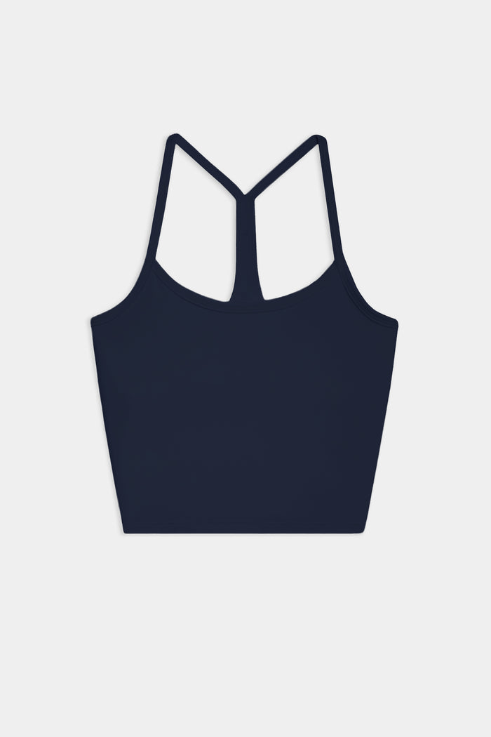 The SPLITS59 Airweight Crop in Indigo, a racerback sports bra ideal for hot yoga, is shown on a plain white background.