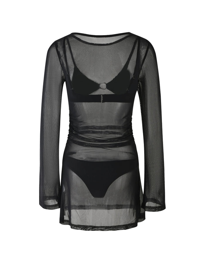 The ALAYNA THREE PIECE MINI DRESS - BLACK from TIGERMIST is a sheer black mesh mini dress featuring long sleeves and a round neckline. The dress has a fitted silhouette and includes visible inner black bra and panties through its translucent fabric.