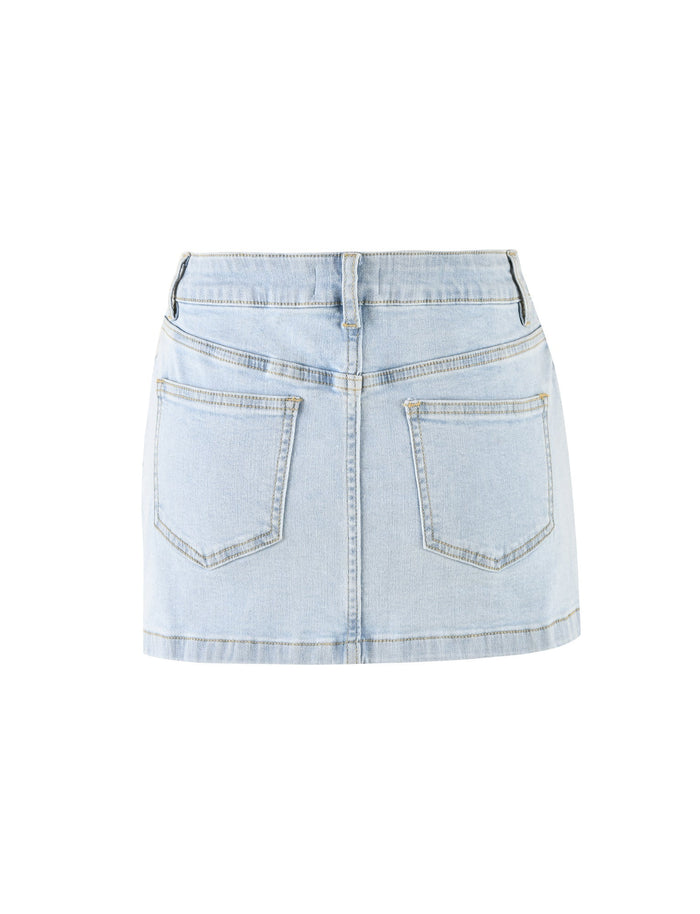 The AMAYA MINI SKIRT - BLUE : LIGHT WASH from TIGERMIST is shown from the back. It features two large back pockets, visible stitching, belt loops, and a waistband. The denim has a slightly faded appearance, giving it a casual look. The skirt hem is straight and falls above the knees.
