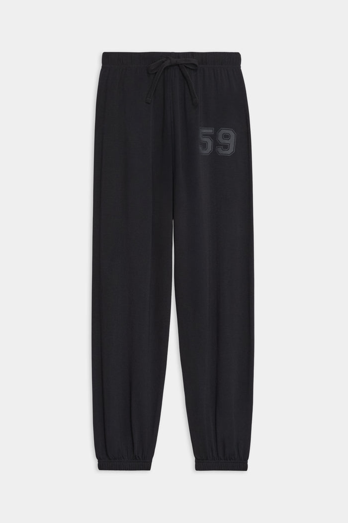 The SPLITS59 Andie Oversized Fleece Varsity 59 Sweatpant in Black features an elastic waistband, adjustable drawstring, elastic cuffs, and "59" embroidery—crafted in Los Angeles for cool weather workouts.