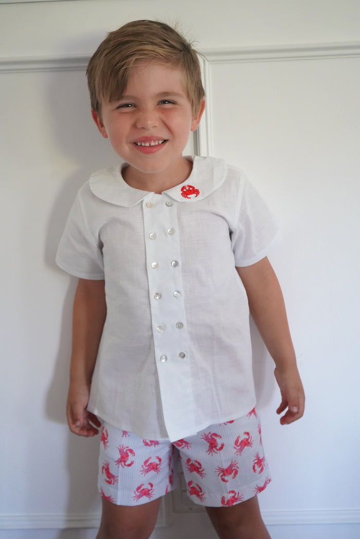 Boy wearing white Crab Boy shirt with coordinating crab print shorts
