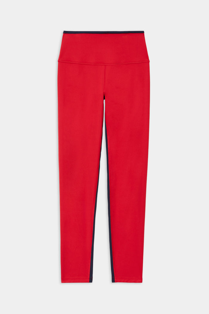 The SPLITS59 Easton Rigor High Waist 7/8 leggings in Pirate Red/Indigo feature a high-waisted fit, compressive fabric, black waistband, and side panels, shown on a white background.