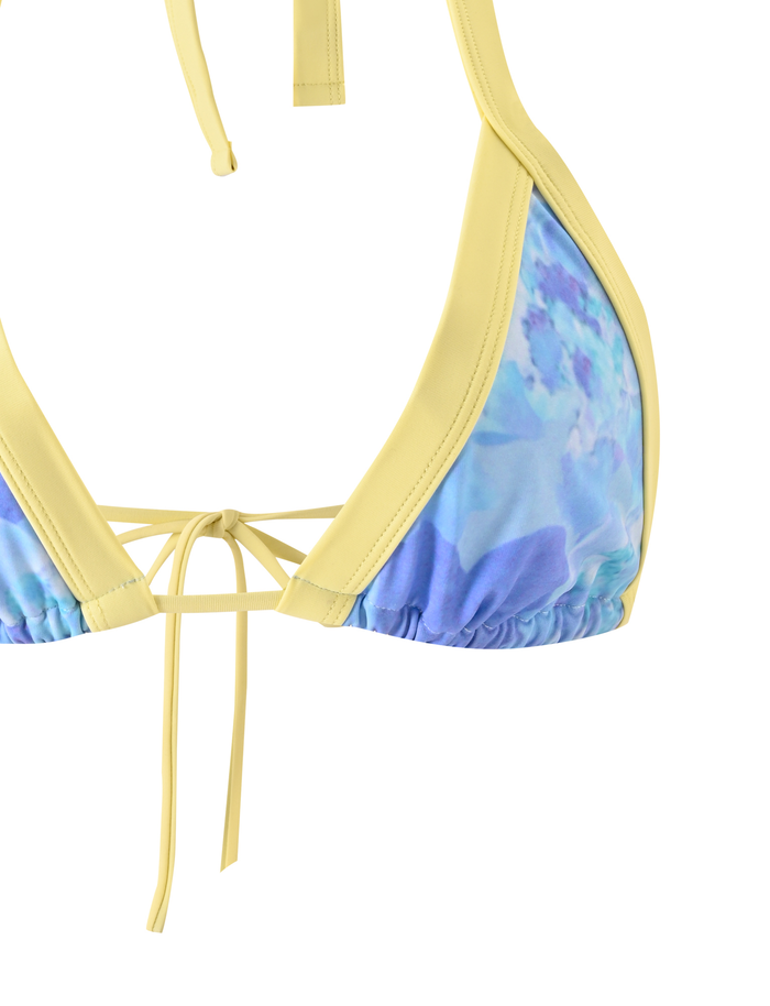 A close-up of the TIGERMIST EMBERLAIN BIKINI TOP - BLUE MACRO FLORAL, featuring blue and yellow floral prints with purple accents and adjustable center and neck ties.