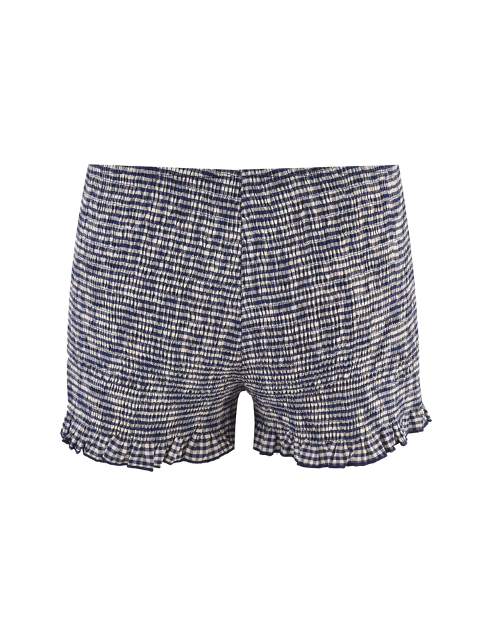 The TIGERMIST ERYNN SHORTS - NAVY GINGHAM feature a blue and white check pattern, smocked texture, and small ruffles at the hem, shown against a plain white background.