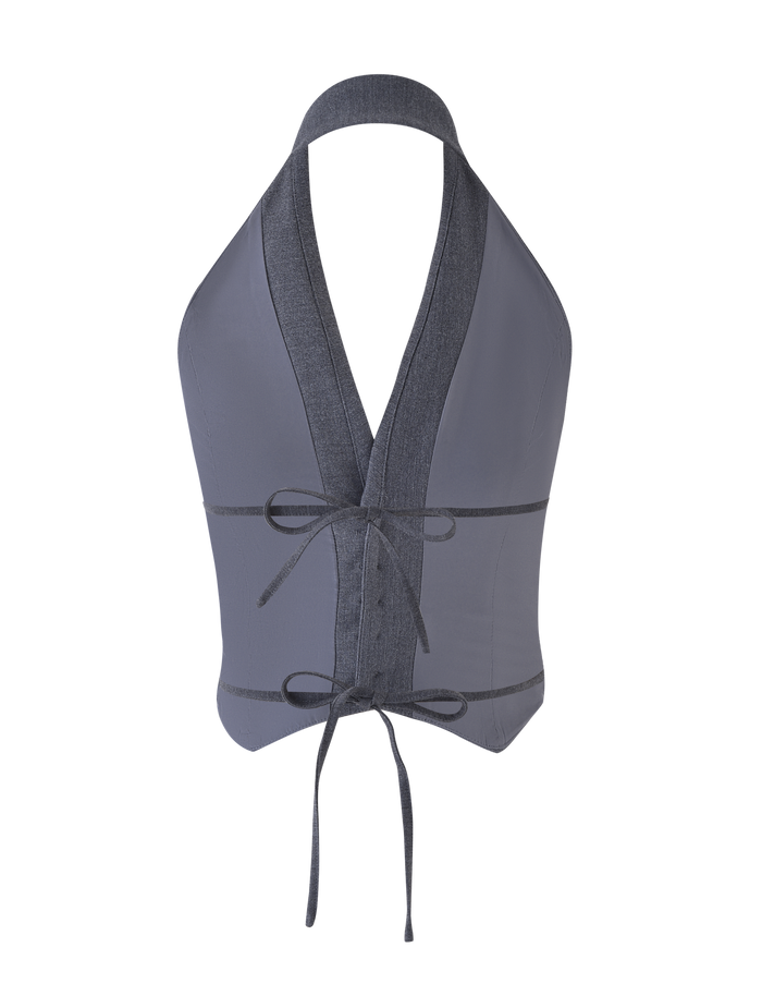 The FEDRA VEST - GREY by TIGERMIST is a gray, backless halter crop top with a tailored fit, deep V-neck, denim-like trim, and tie closures at the waist and neck.