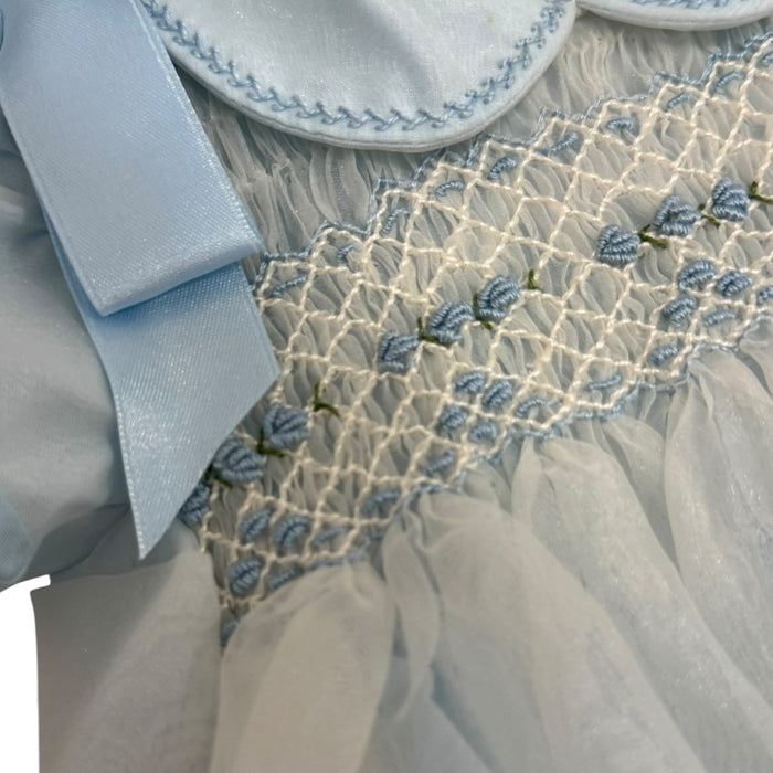 Close-up of contrasting blue trim and handsmocking on Joaquin Light Blue Romper