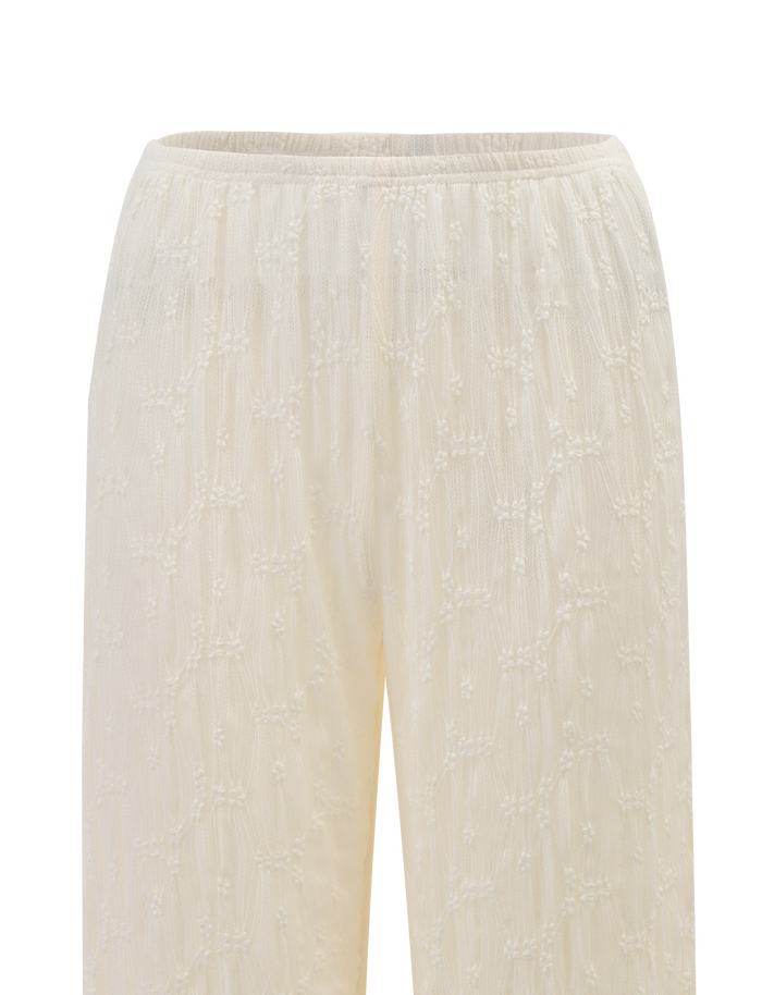 Close-up of TIGERMIST’s KATERINA PANT in ivory lace, featuring an elasticated waist and a delicate, textured grid pattern with embroidered dots and lines.