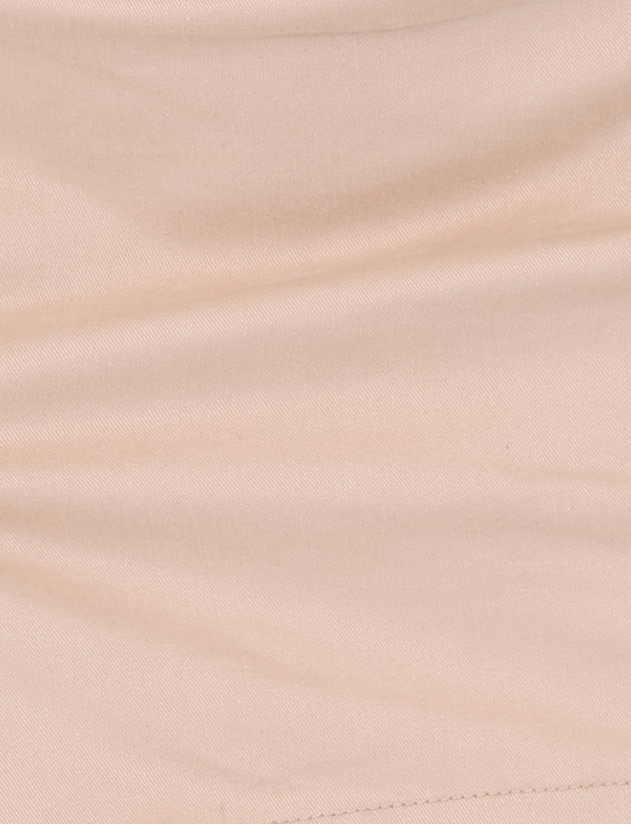 Close-up of the TIGERMIST KITTIE SKORT - TAN showcases its soft fabric, visible stitching, gentle creases, and mini length appeal.
