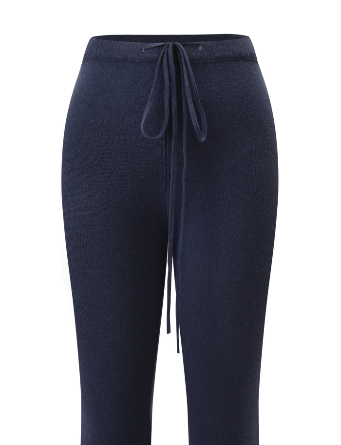 The LEORA PANT - NAVY by TIGERMIST features a relaxed knit design with a drawstring waist, shown from the front against a white background.