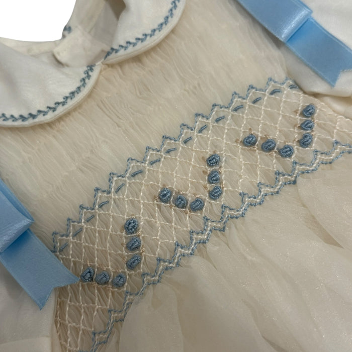Close-up of light blue handsmocking and collar detailing on Luis Ivory Romper