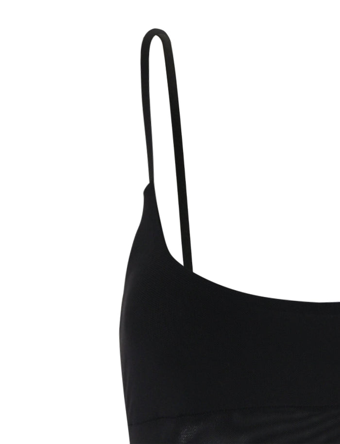 A close-up view of the Tiger Mist OCTAVIA DRESS - BLACK features its narrow shoulder straps and sleeveless design. The fabric appears smooth and stretchy, likely made from spandex or a cotton blend, and the image highlights the simple, elegant design of the upper portion of this dress.