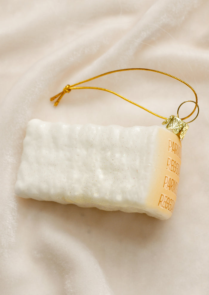 A glass ornament designed to look like a wedge of parmesan cheese.
