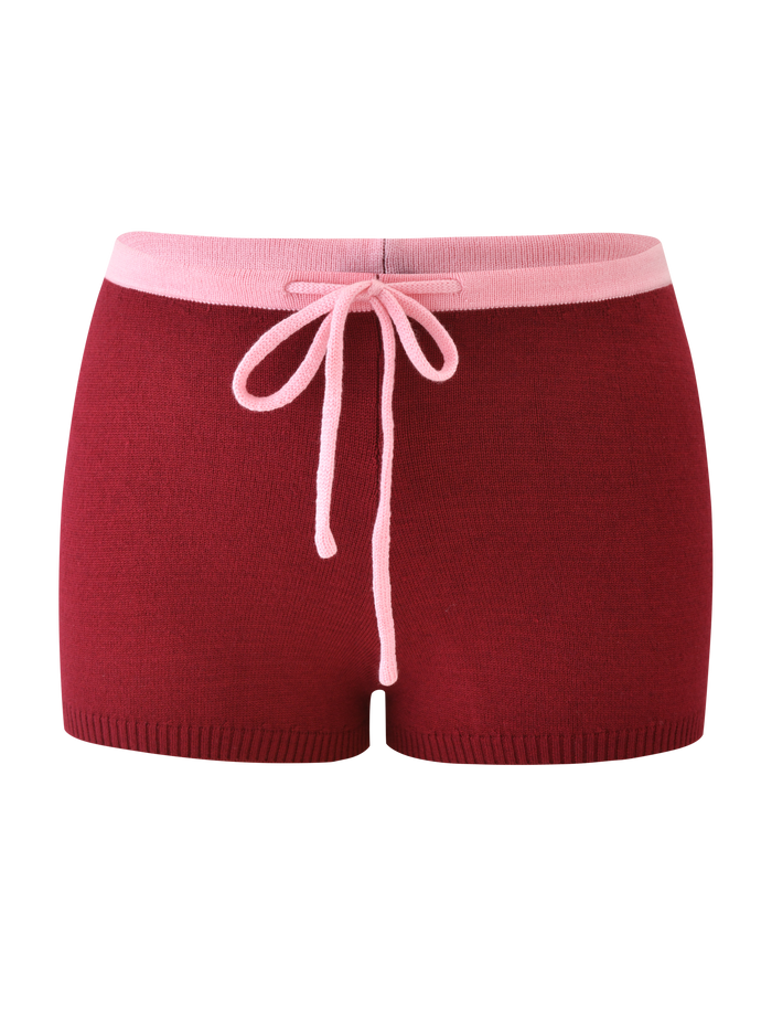 The ROUX SHORT - RED by TIGERMIST features a red knit design with a light pink waistband and matching drawstring, shown against a plain white background.