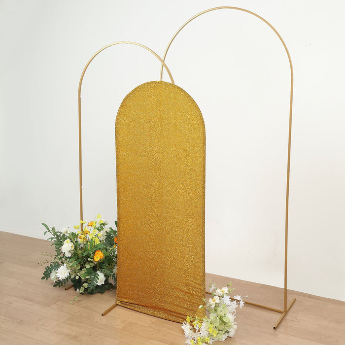 Gold glitter backdrop with gold arches and floral arrangement