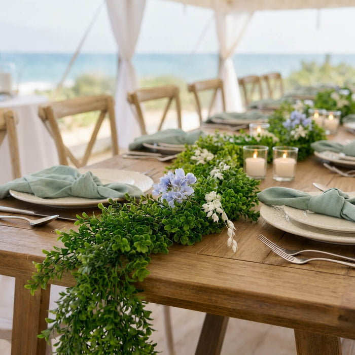 9ft faux boxwood garland with blue flowers on an outdoor beach wedding table centerpiece