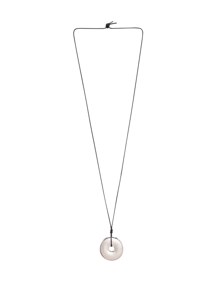 The TIGERMIST AIFE PENDANT NECKLACE - SILVER features a minimalist design with an adjustable black cord and a round, flat silver pendant with a central hole. The knotted cord allows for easy length adjustment.