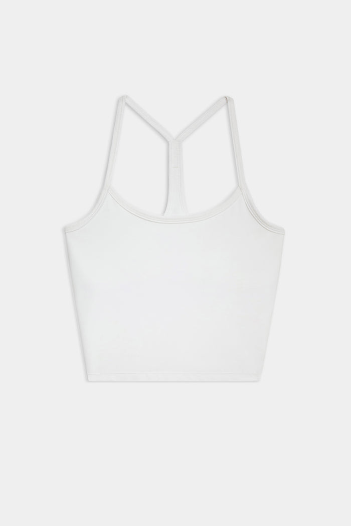 The SPLITS59 Airweight Crop - White is a racerback tank top with spaghetti straps, ideal for hot yoga, shown on a white background.