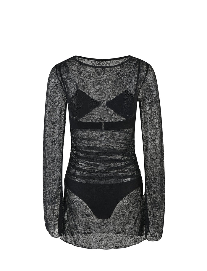 The ALAYNA THREE PIECE MINI DRESS - BLACK : BLACK LACE from TIGERMIST features a black, sheer lace fabric with long sleeves and intricate floral patterns. Its fitted yet flowy design is slightly cinched at the waist, complemented by matching black lace undergarments that are visible through the sheer material. The dress is showcased on a plain white background.