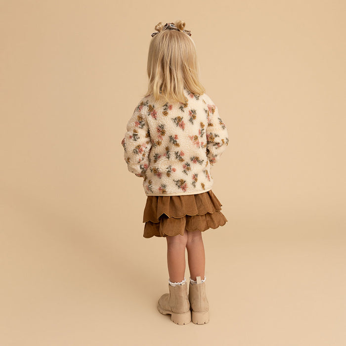 Girl standing, side view, wearing the Amber print sherpa jacket