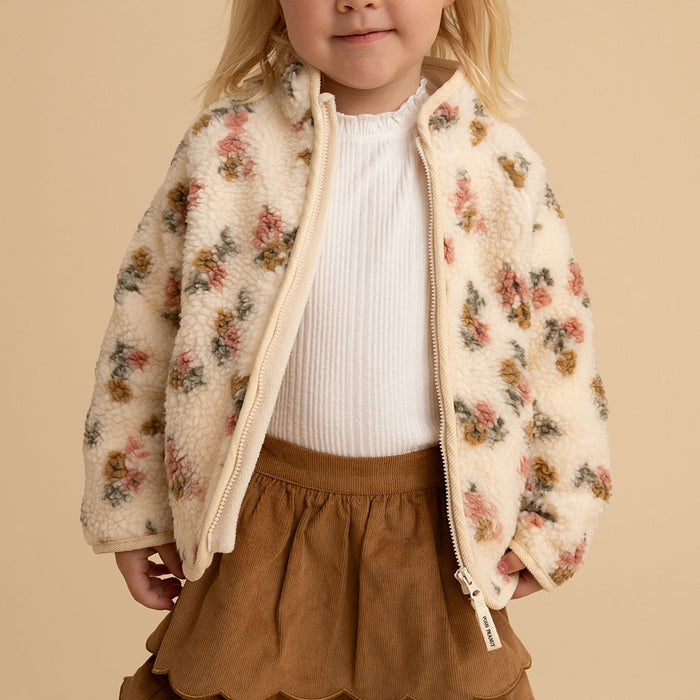 Close-up of a girl wearing the Amber print sherpa jacket, front view