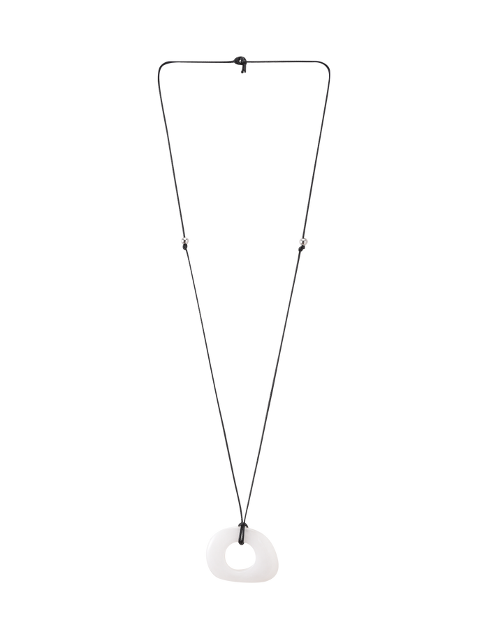The AMYRA PENDANT NECKLACE - WHITE by TIGERMIST features a long adjustable cord and an irregular white clear resin pendant with a central hole, showcased on a plain white background.
