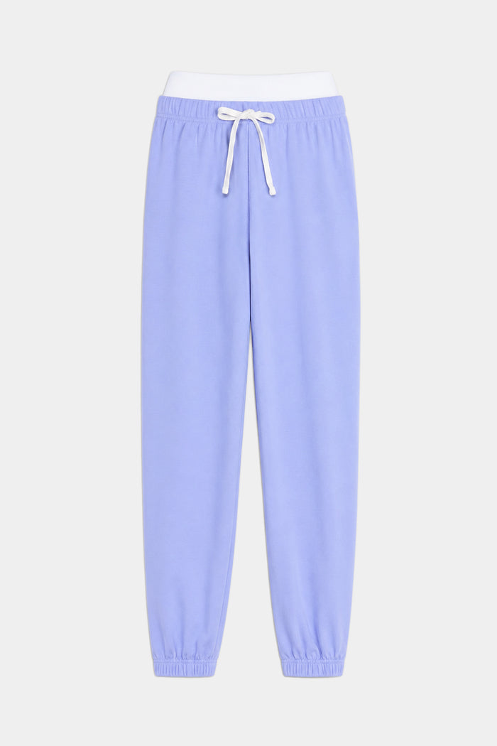 The SPLITS59 Andie Dual Waist Sweatpant in Purple Haze/White features soft modal fabric, a white drawstring, elastic waistband, and ankle cuffs, shown against a plain white background.