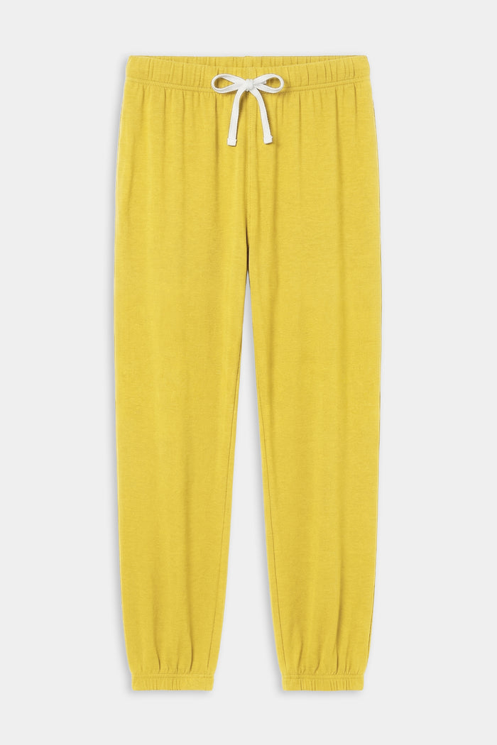 The SPLITS59 Andie Oversized Fleece Sweatpant in Bright Yellow features an elastic waistband, white drawstring, and elastic cuffs—ideal for cool weather workouts. Expertly made in Los Angeles and shown laid flat on a white background.