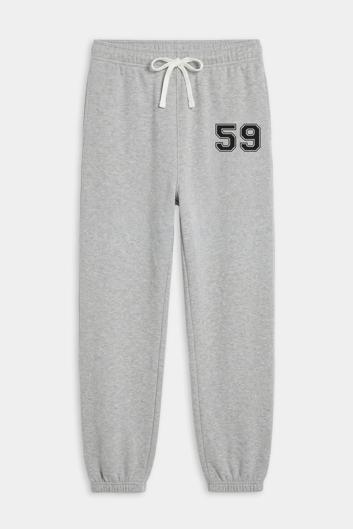 The SPLITS59 Andie Oversized Fleece Varsity 59 Sweatpant in heather grey features an elastic waistband, white drawstring, and black "59" print on the left thigh for an ultra luxe look.