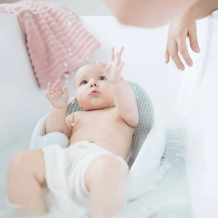 Baby in bath seat with Angelcare Bath Support, perfect for Toshi baby romper fun