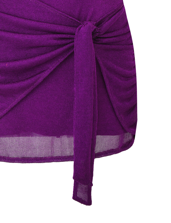 Close-up of the AZELMA DRESS in purple by TIGERMIST, featuring a fitted ribbed silhouette with a front tie knot, ruched detailing, and a slightly sheer cropped hem. Only part of the dress is visible in the image.