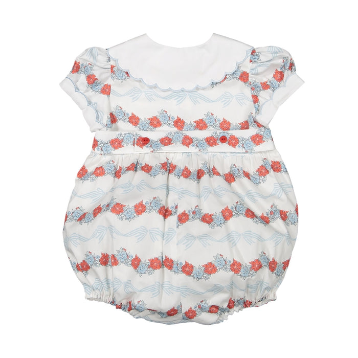 Back view of Breeze Floral and Bows Romper in coral floral and light blue bow print