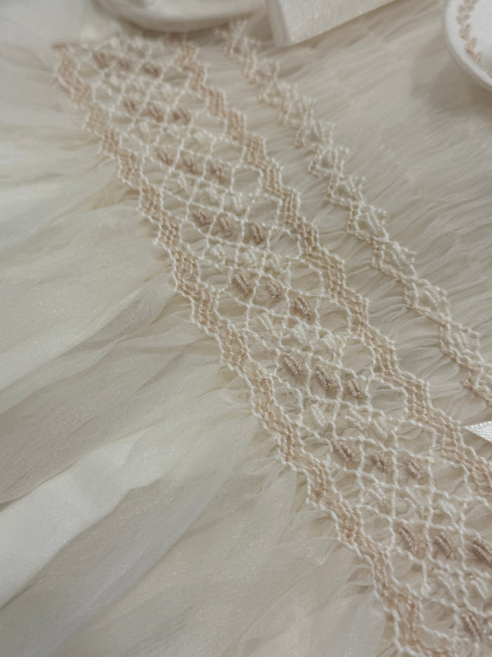 Close-up of intricate embroidered and smocked detailing on Brice Ivory Romper