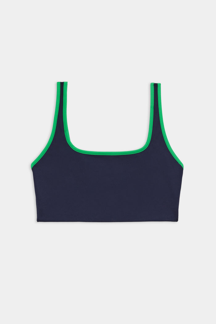 The SPLITS59 Cait Rigor Bra in Indigo/Grass features a square neckline, green trim, and high-performance Rigor fabric for supportive comfort—ideal for high-impact workouts. Shown on a white background.