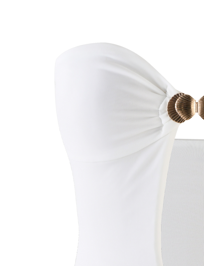 Close-up of the TIGERMIST CECILY MINI DRESS in white, featuring a strapless, fitted silhouette with side ruching and gathered at the top with a round metallic gold accent.