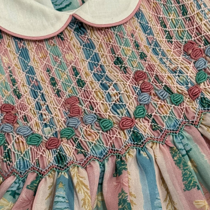 Close-up of rounded ivory collar and intricate handsmocking on Christmas Tree Pastels Romper