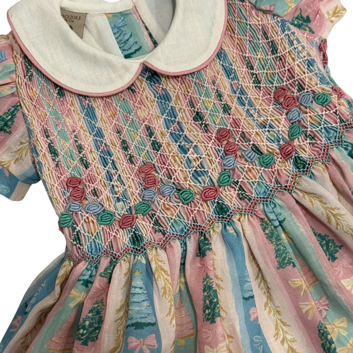Close-up of pastel Christmas tree print and handsmocked bodice detailing