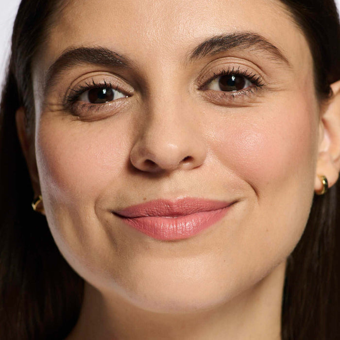 No Makeup Makeup – light medium skin model wearing pink 01 Creme Classic Lipstick shade smiling, natural minimal makeup