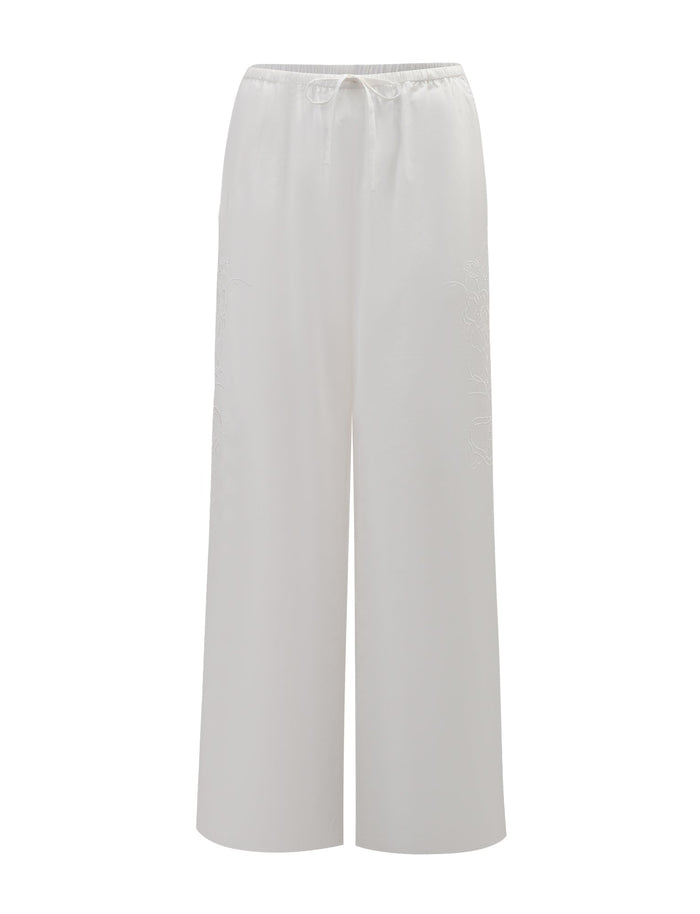 The TIGERMIST CRESSY PANT - WHITE features a full-length, loose wide-leg design with an elastic waistband and drawstring tie, shown on a plain white background.