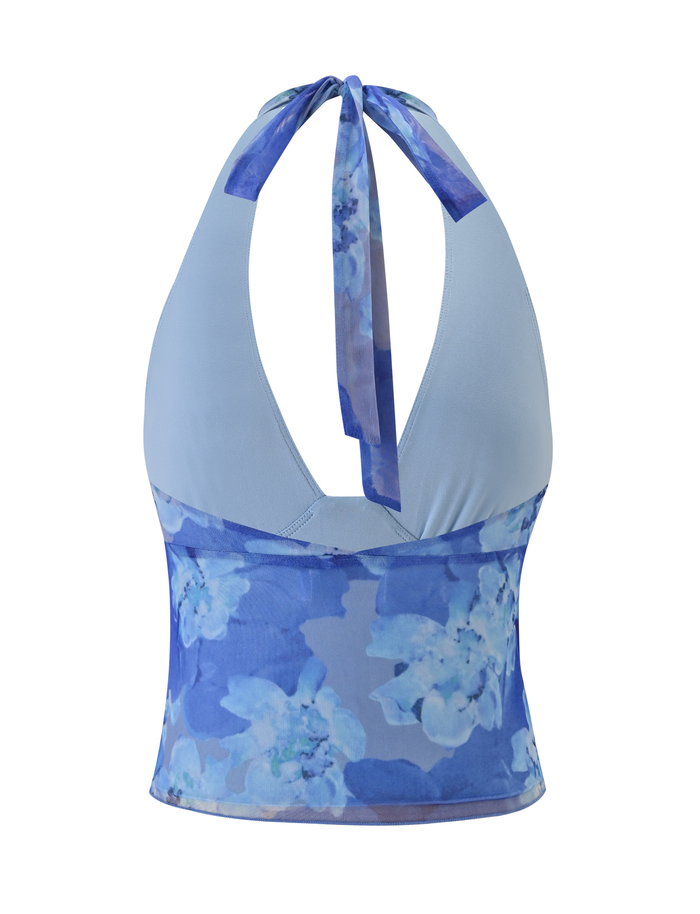 The DEVYN TOP by TIGERMIST is a blue macro floral halter top with a tie-back neck, bodycon fit, and smooth, slightly sheer high-stretch fabric that blends light blue with blue and white floral prints for a feminine look.
