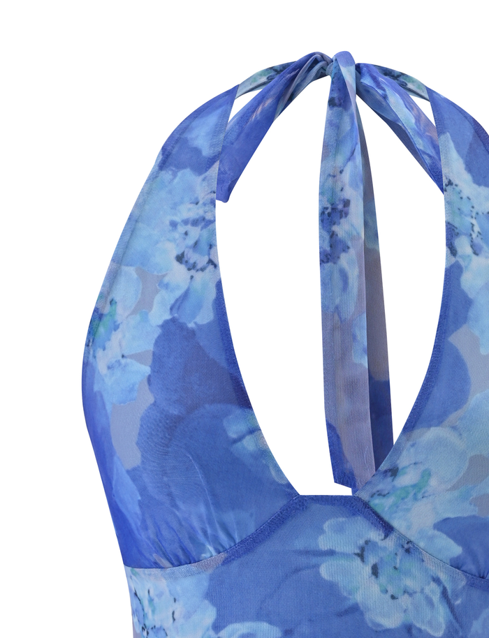 Close-up of the TIGERMIST DEVYN TOP - BLUE MACRO FLORAL, a blue halter bodycon with back ties and high-stretch fabric adorned in blue and white floral prints.