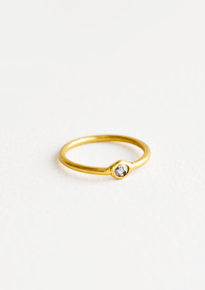 Yellow brass ring with a slim band and a small diamond stone.