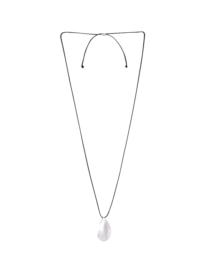 The TIGERMIST ERRIS PENDANT NECKLACE - CREAM features a minimalist design with a thin black cord and an oval, translucent white pendant. This adjustable necklace is shown on a plain light gray background.