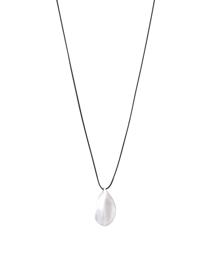 The TIGERMIST ERRIS PENDANT NECKLACE - CREAM features a minimalist design with a thin black cord and an irregular silver leaf pendant at the center, offering adjustable effortless elegance for any style—perfect against a plain white background.