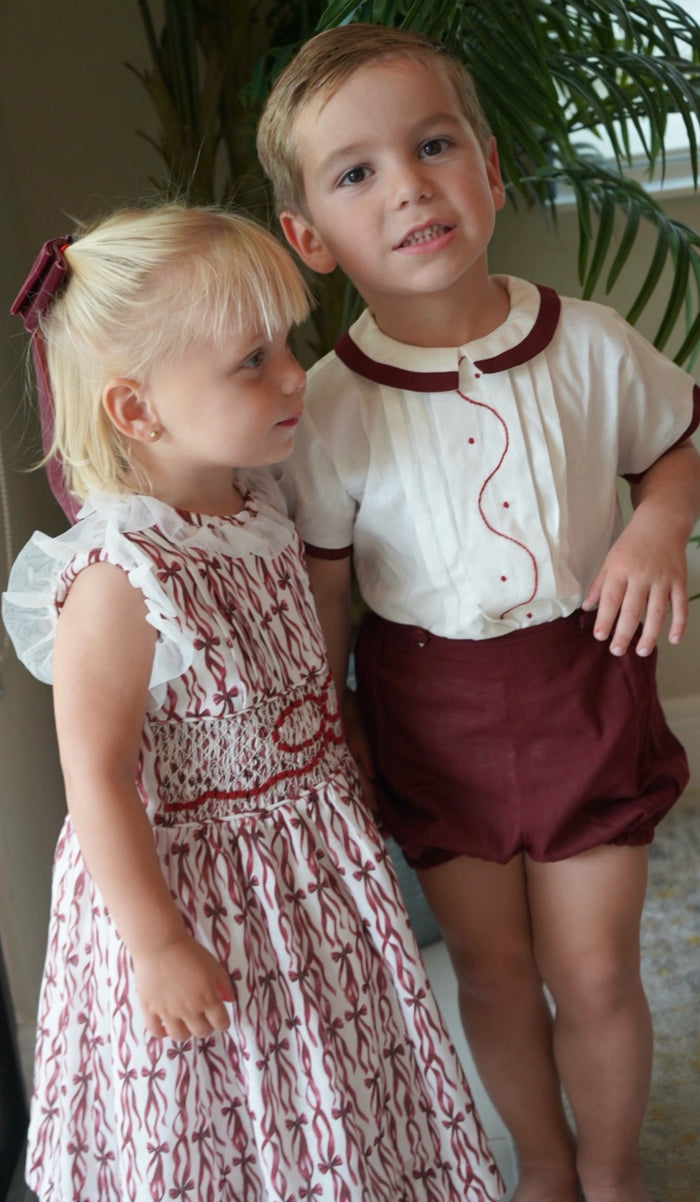 Children wearing coordinating Every Day is a Gift Burgundy Christmas outfits