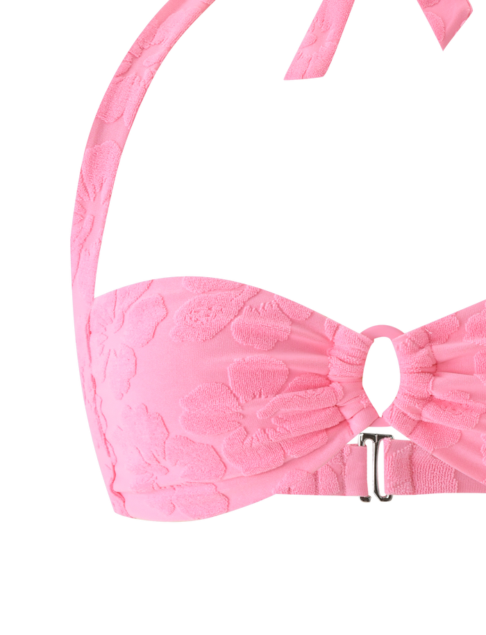 Close-up of the TIGERMIST FIORA BIKINI TOP in baby pink, showcasing halter straps, a floral textured pattern, a central keyhole cutout, and a small metallic front clasp.
