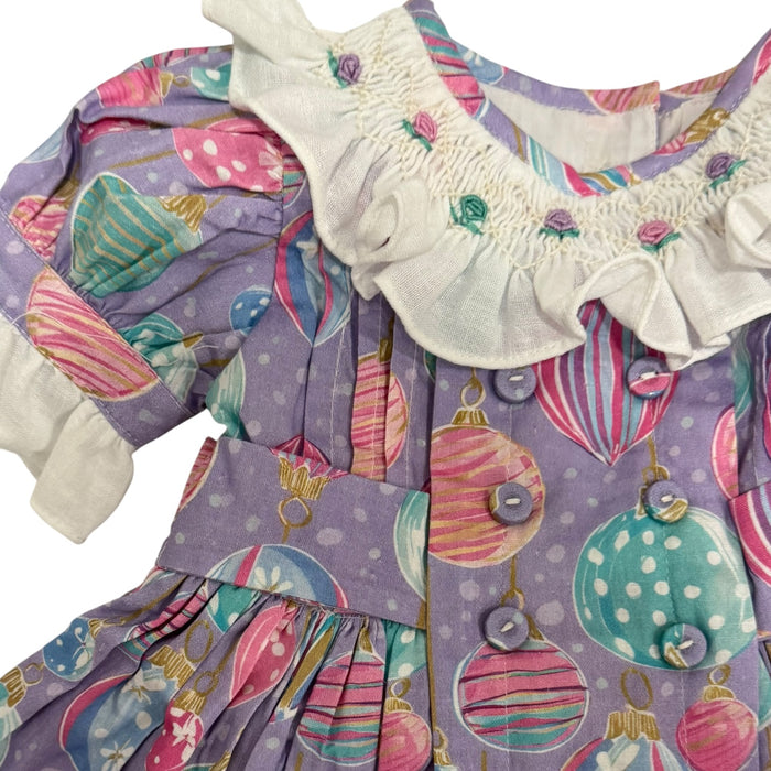 Close-up of ruffled ivory collar and handsmocked bodice on Gigi Ornaments Pastels Dress