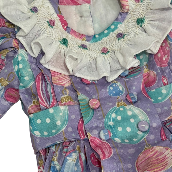 Close-up of embroidered ivory collar and colorful smocking on Gigi Ornaments Pastels Romper