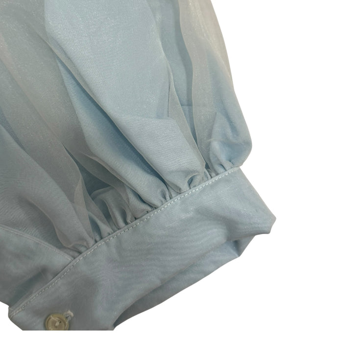 Close-up of puffed sleeve and gathered cuff on Grego Light Blue Romper